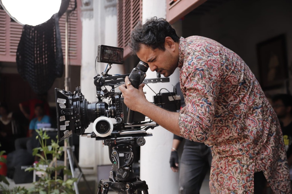 Tathagata looking through camera lens